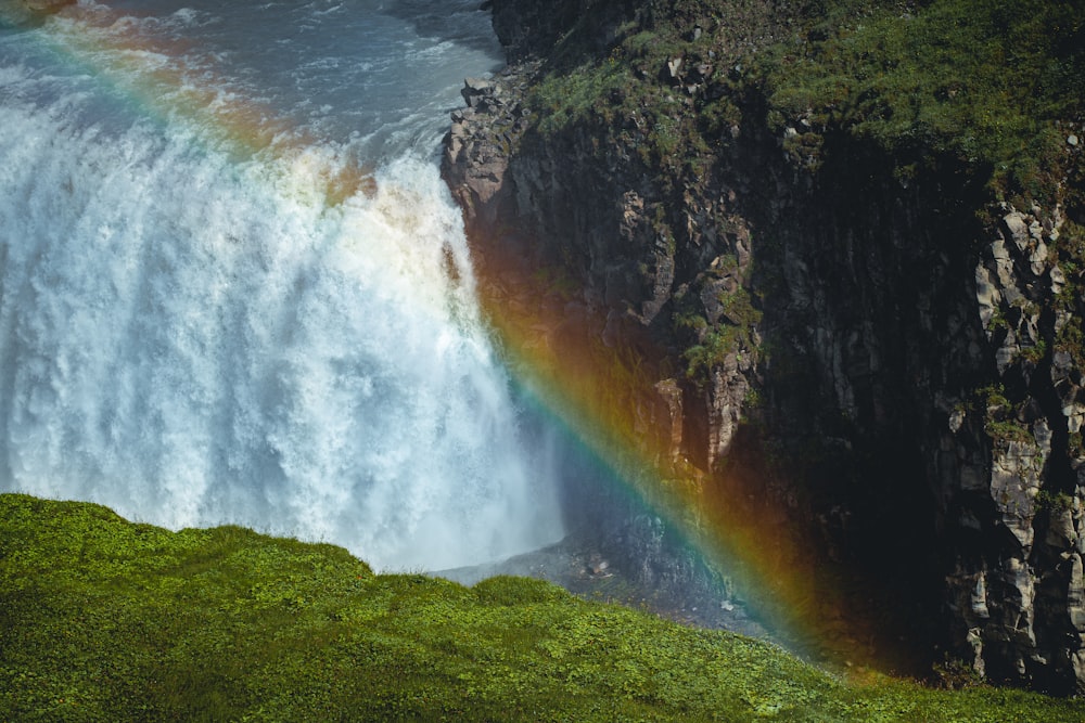 a waterfall with a rainbow in the middle of it