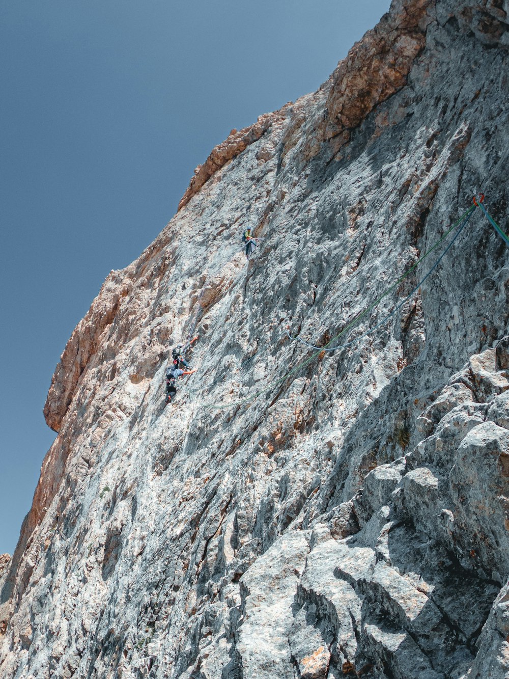 a man climbing up the side of a mountain