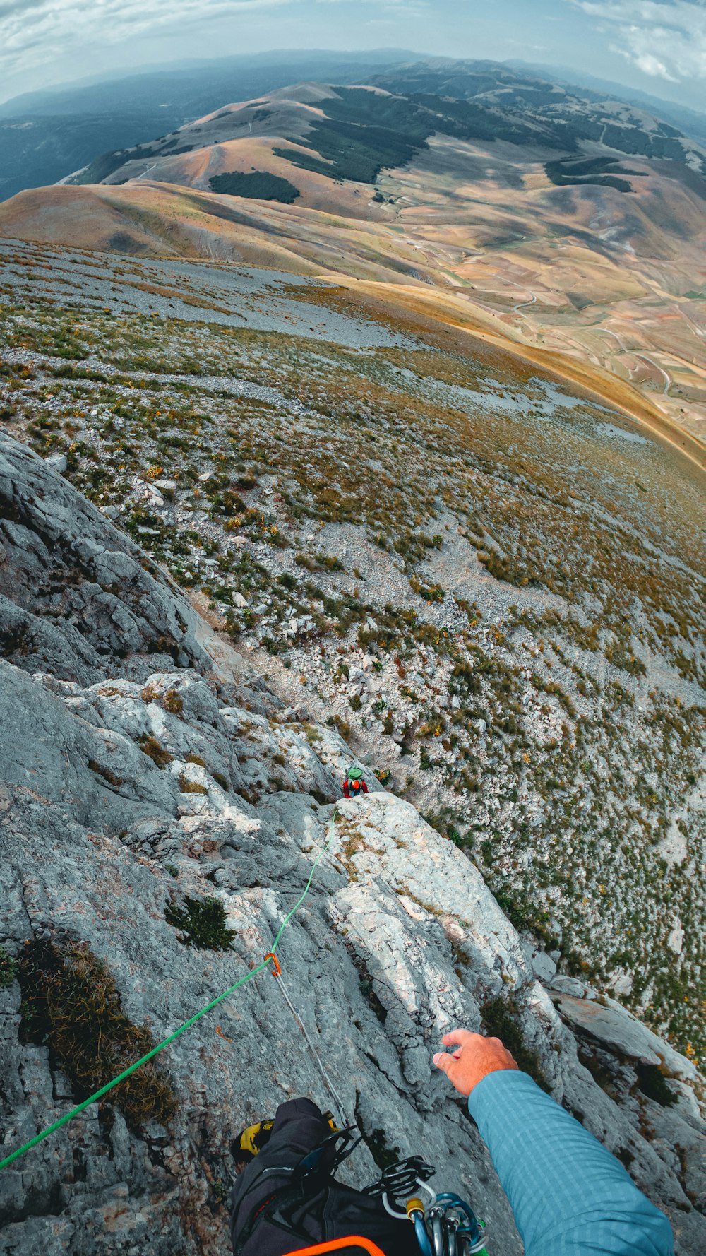 a person on a rock climbing up a mountain