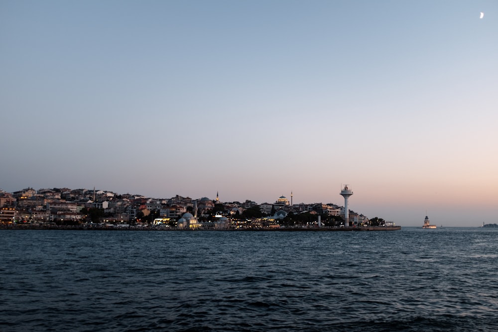 a large body of water with a city in the background