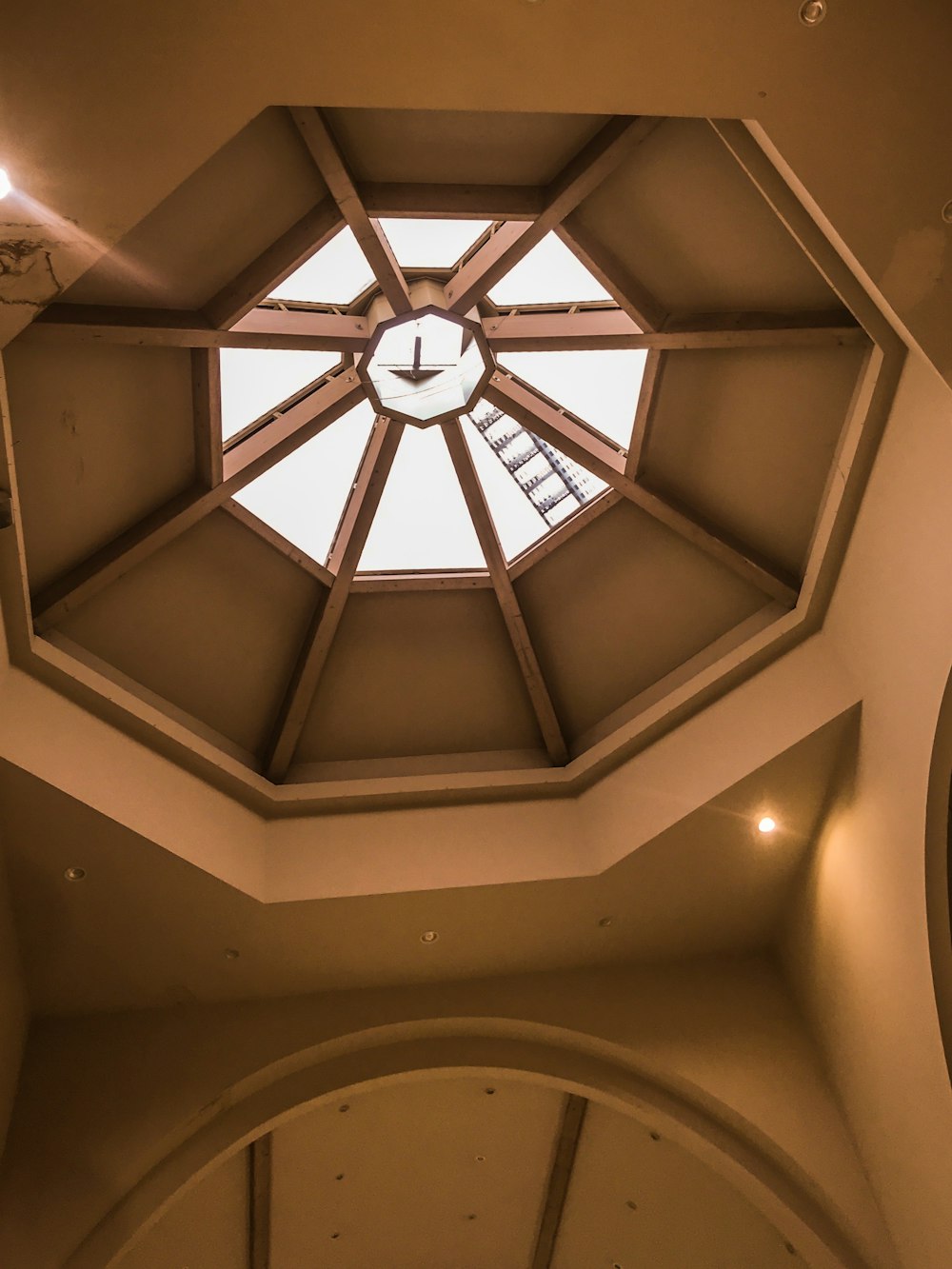 a clock mounted to the ceiling of a building