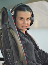 A friendly dispatcher speaking on a headset with a truck driver.