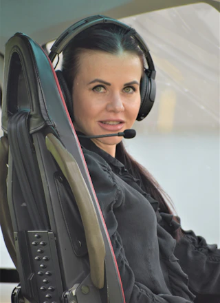 A friendly customer service representative wearing a headset, assisting a transport company client.