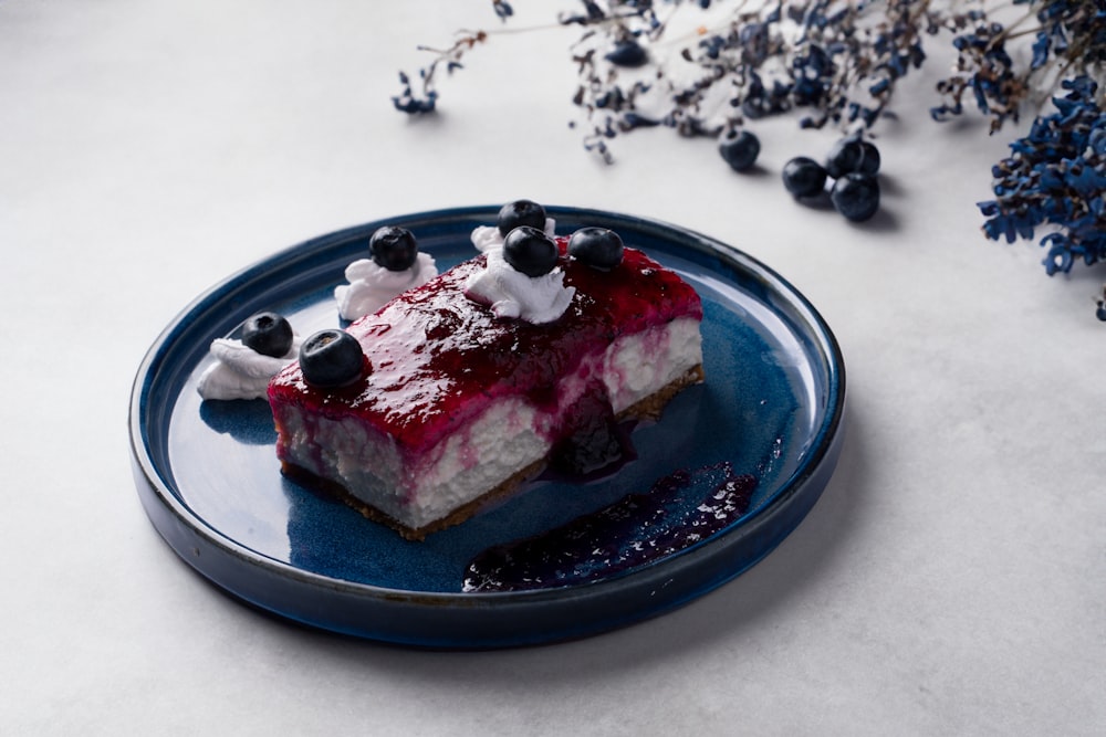 a blue plate topped with a piece of cake