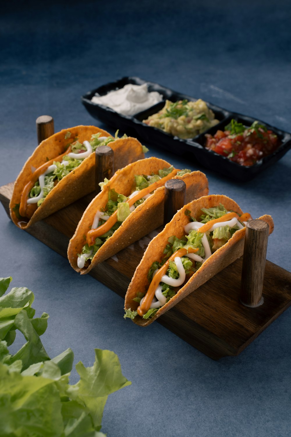 a group of tacos sitting on top of a wooden tray