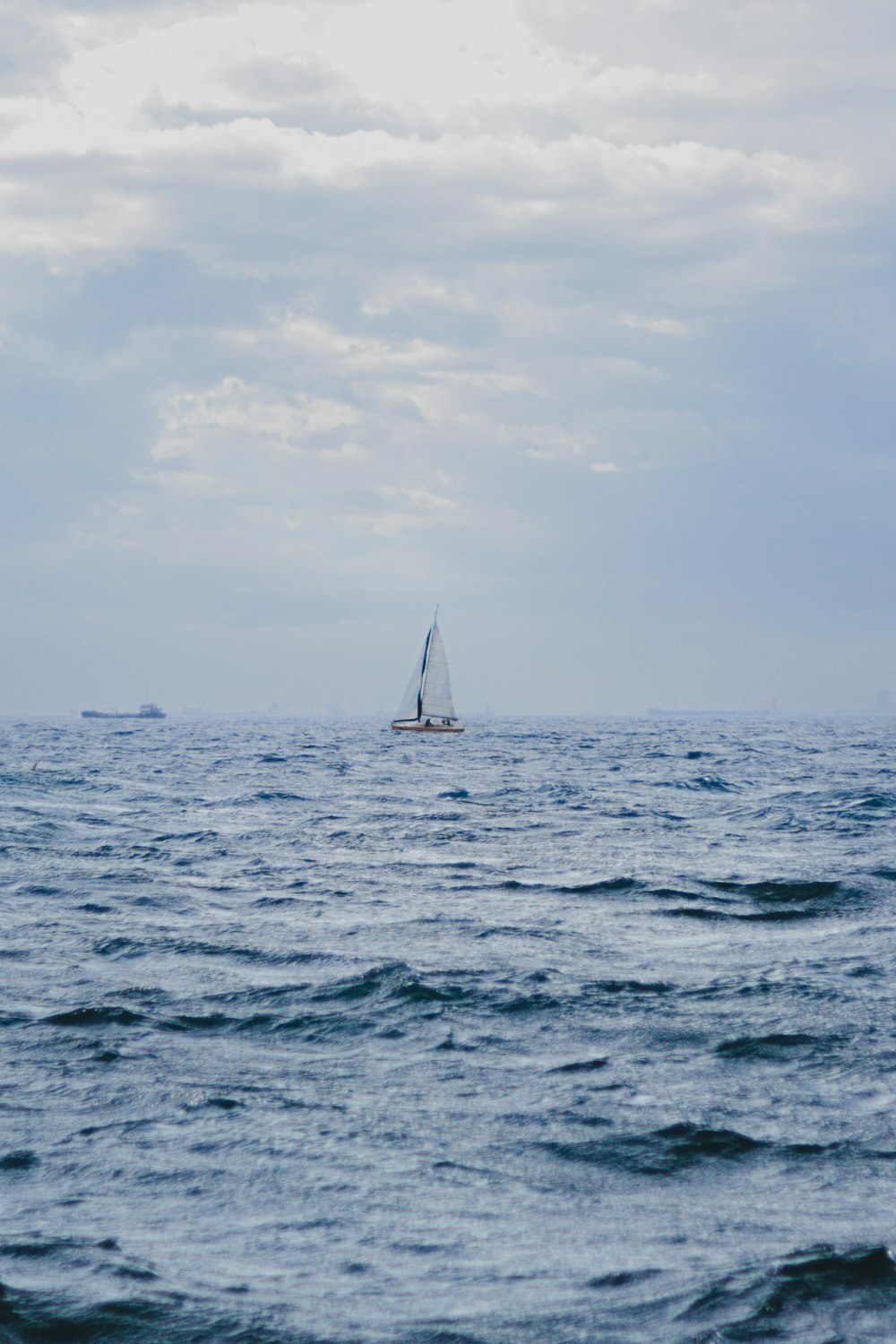 a sailboat in the middle of the ocean