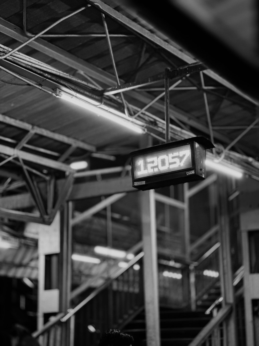 a sign hanging from the ceiling of a building