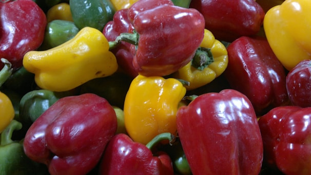 Colorful bell peppers in red, yellow, and green, freshly harvested.