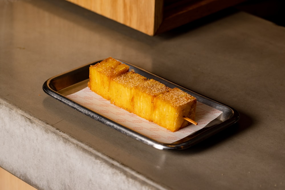 a piece of cake sitting on top of a metal tray