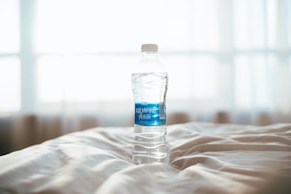 A family happily drinking purified water at home with Agua Pura Kawaii bottles on the table.