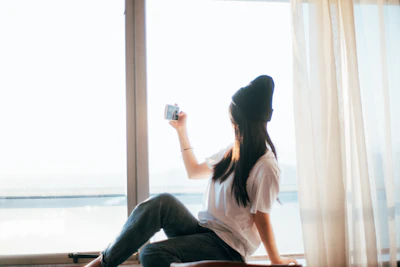 A candid photo of a content creator filming a video with natural light.