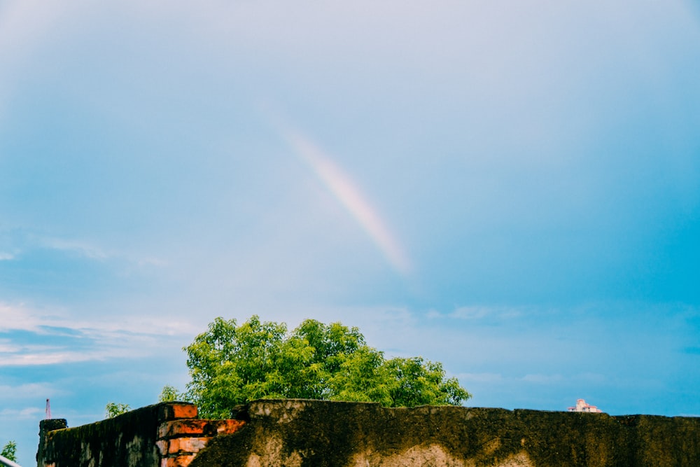a rainbow is seen in the sky over a building