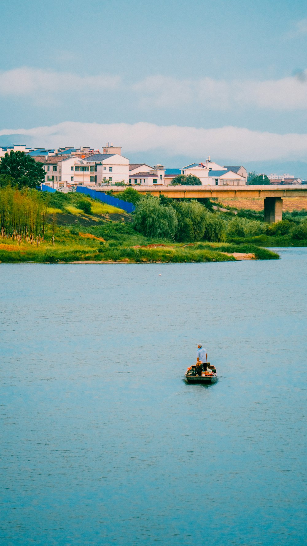 a man on a small boat in the middle of a lake