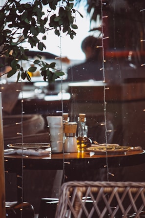 Warm, elegant table setting with olive oil and Spanish conserves in a cozy kitchen.