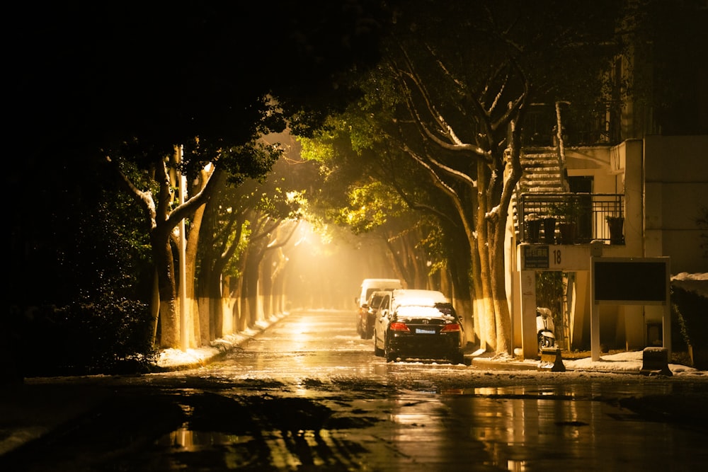 a car driving down a street at night