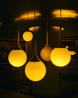 A cozy living room softly illuminated by elegant pendant lights from Vitor Hugo Pimentel Nascimento's collection.