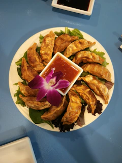 a plate of food with a flower on it