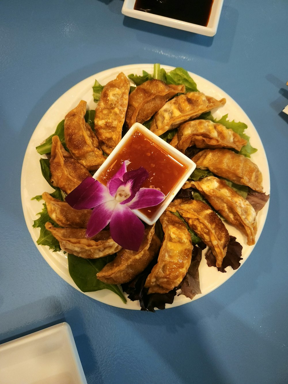 a plate of food with a flower on it