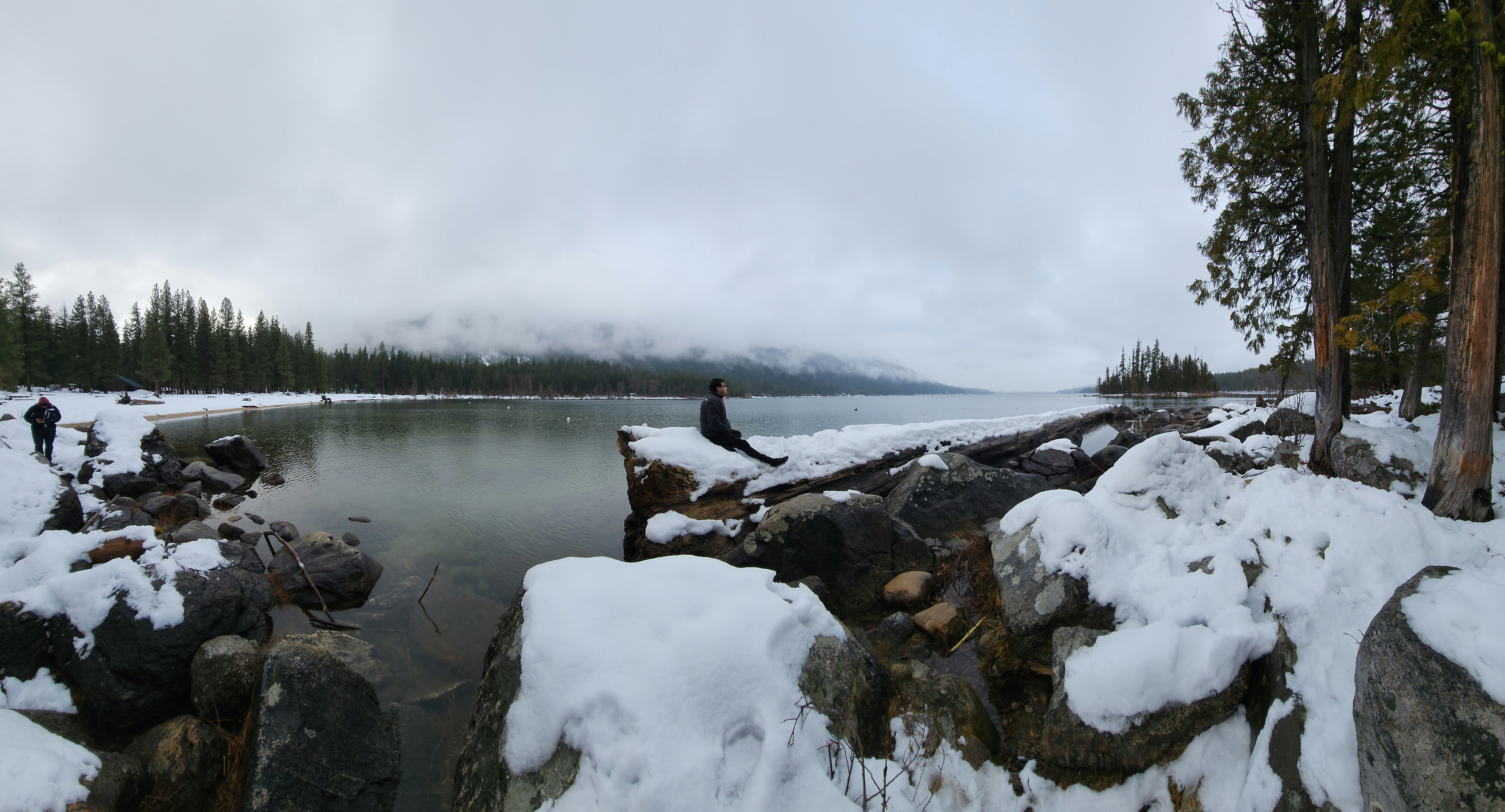 a man standing on a rock next to a body of water, Stopped by Lake Wenatchee near Leavenworth, Washington