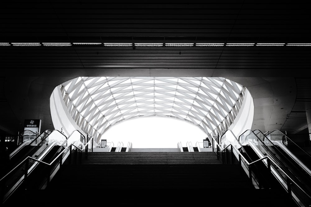 a black and white photo of an escalator