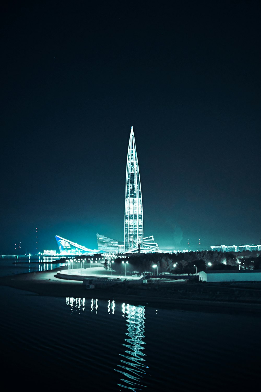 a very tall building sitting in the middle of a body of water