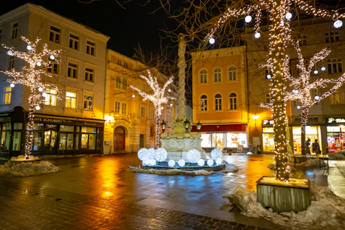 Wide shot of a town square glowing under newly installed LED lighting at night.