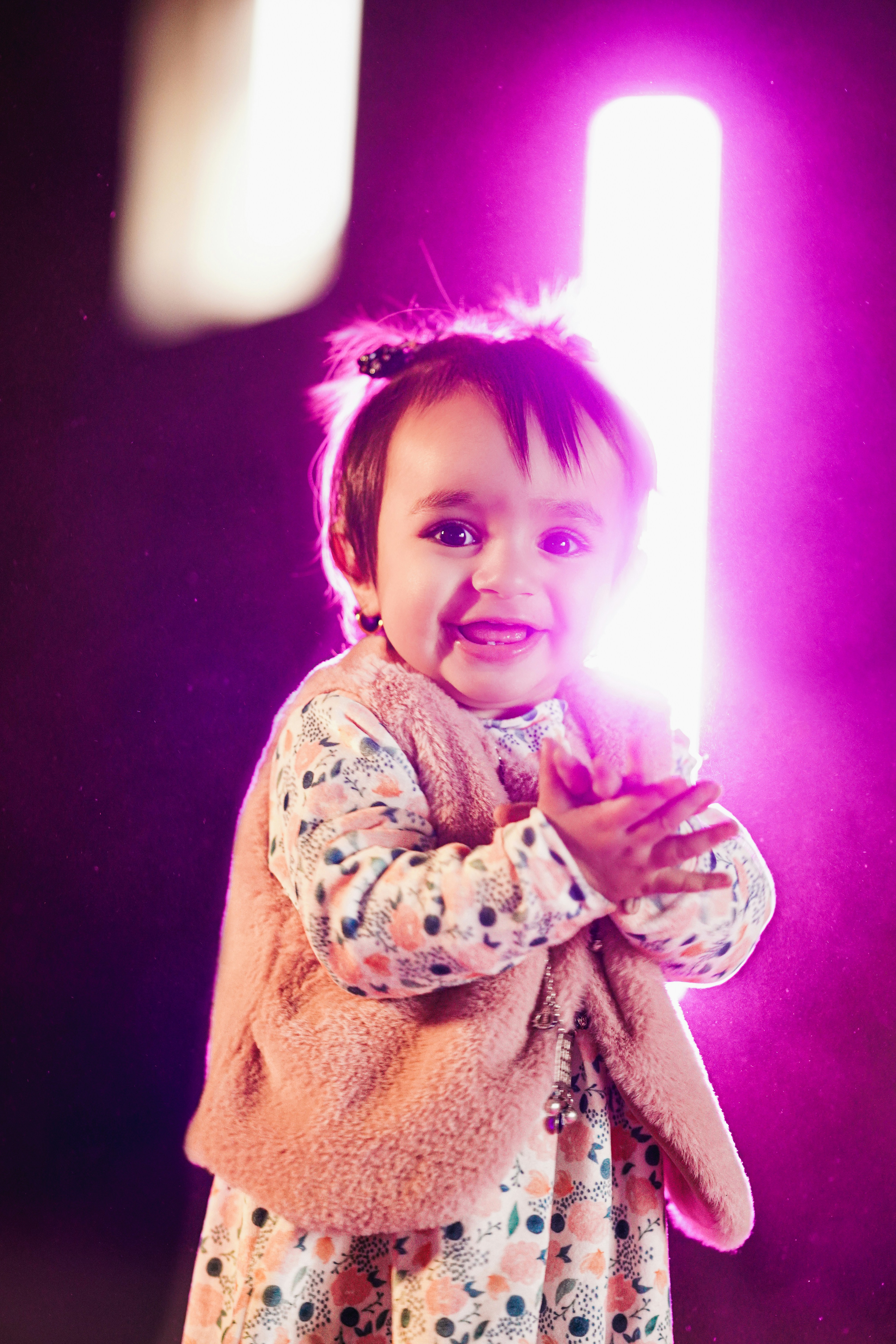 a little girl holding a light saber in her hands