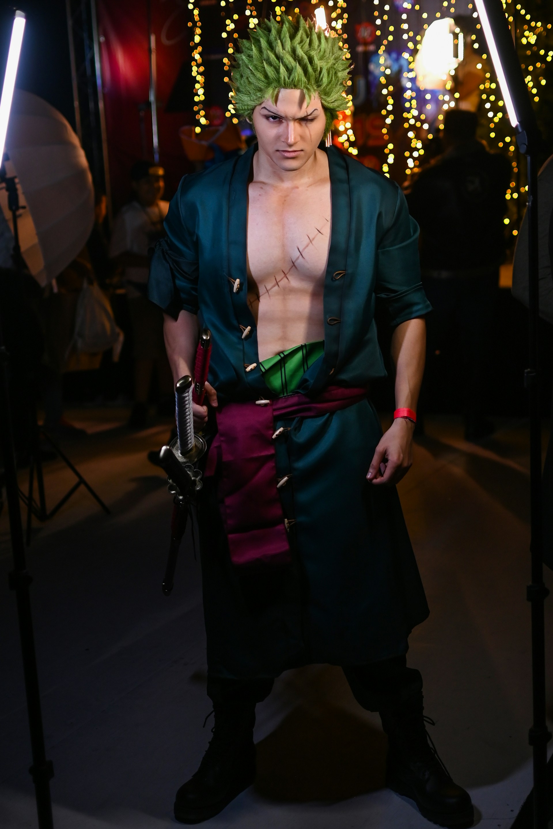 Shadowsylph in an intricate cosplay outfit with jagged black armor and glowing green eyes, blending into the shadowy woods.