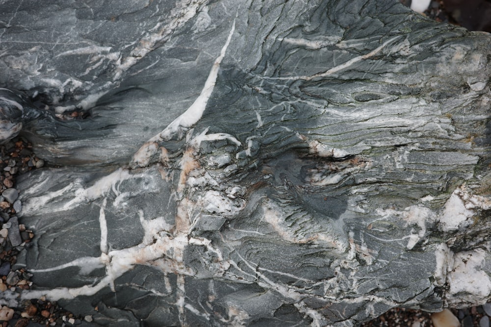 a close up of a rock with white streaks