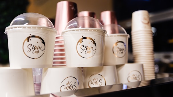 A collection of custom restaurant disposables featuring blue accents and personalized logos arranged neatly on a white surface.