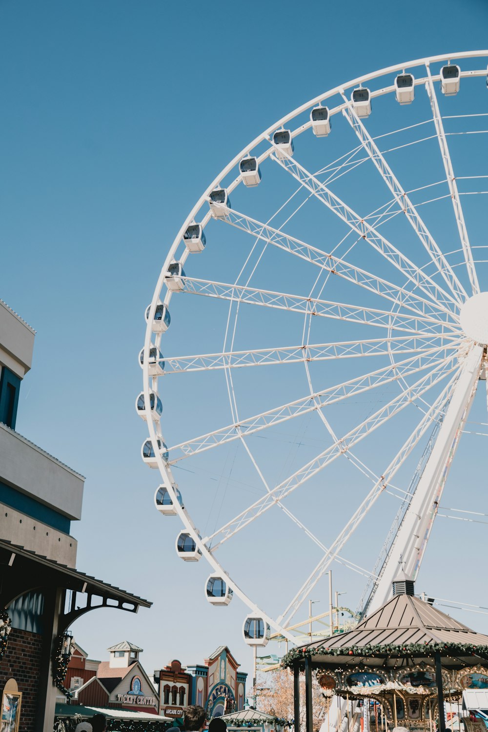 a large white ferris wheel sitting next to a building