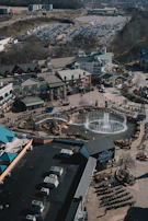 An aerial view of a commercial plaza surrounded by greenery.