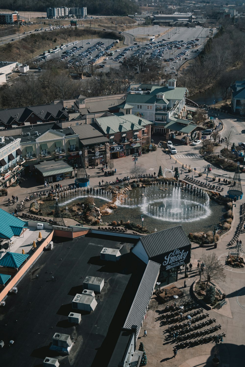 an aerial view of a parking lot with a fountain