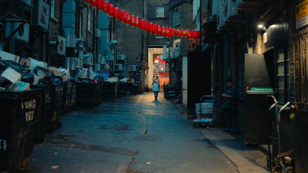 a person walking down a narrow alley way