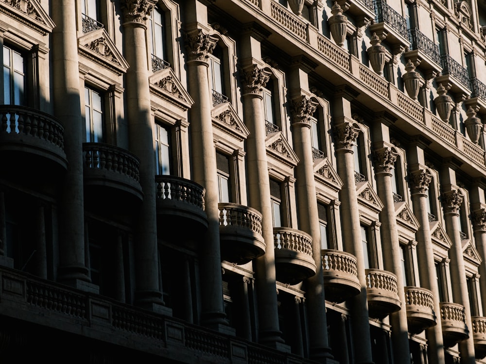 a tall building with many windows and balconies