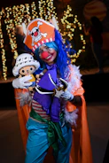 A joyful clown entertaining children with bright costumes and playful antics.