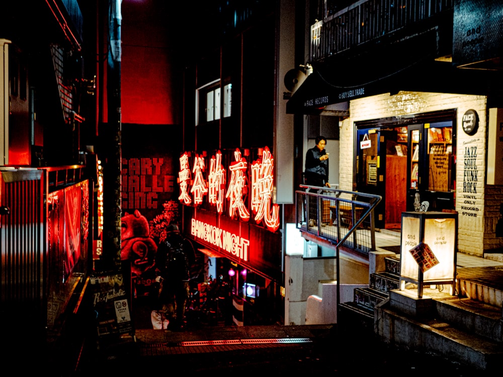 a building with a neon sign on the side of it