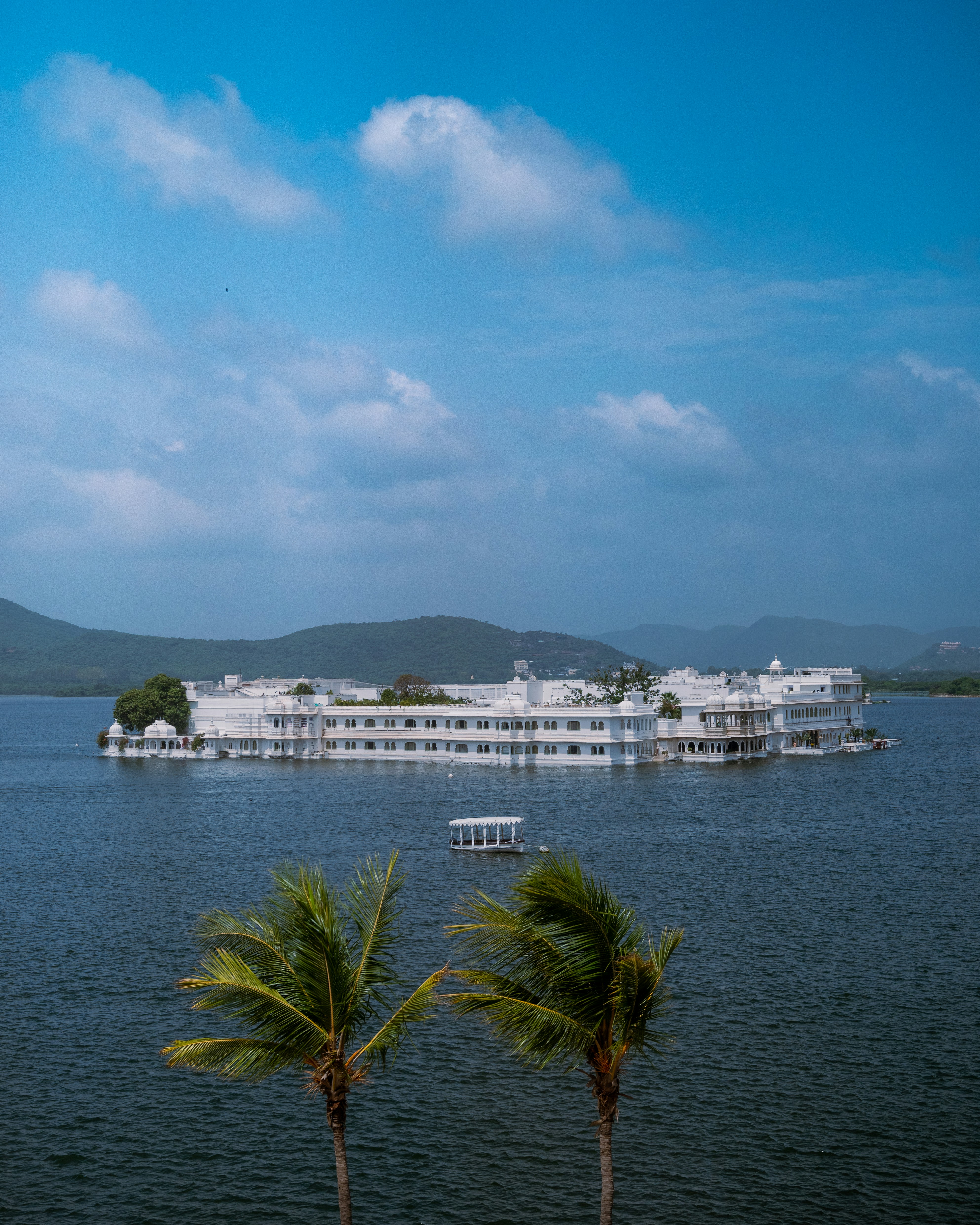 a large white building sitting on top of a lake