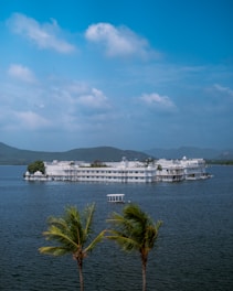 a large white building sitting on top of a lake