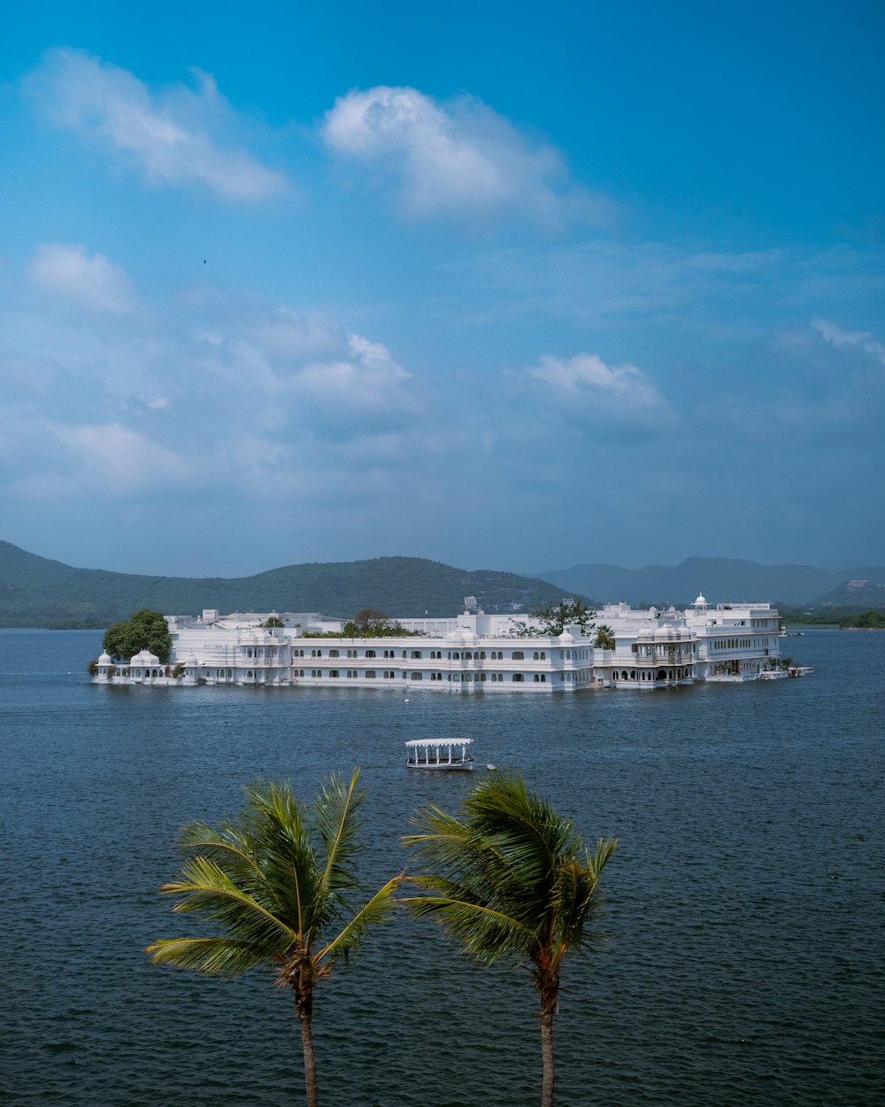 a large white building sitting on top of a lake