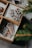 Close-up of a variety of decorated cookies arranged neatly in a rustic box tied with twine