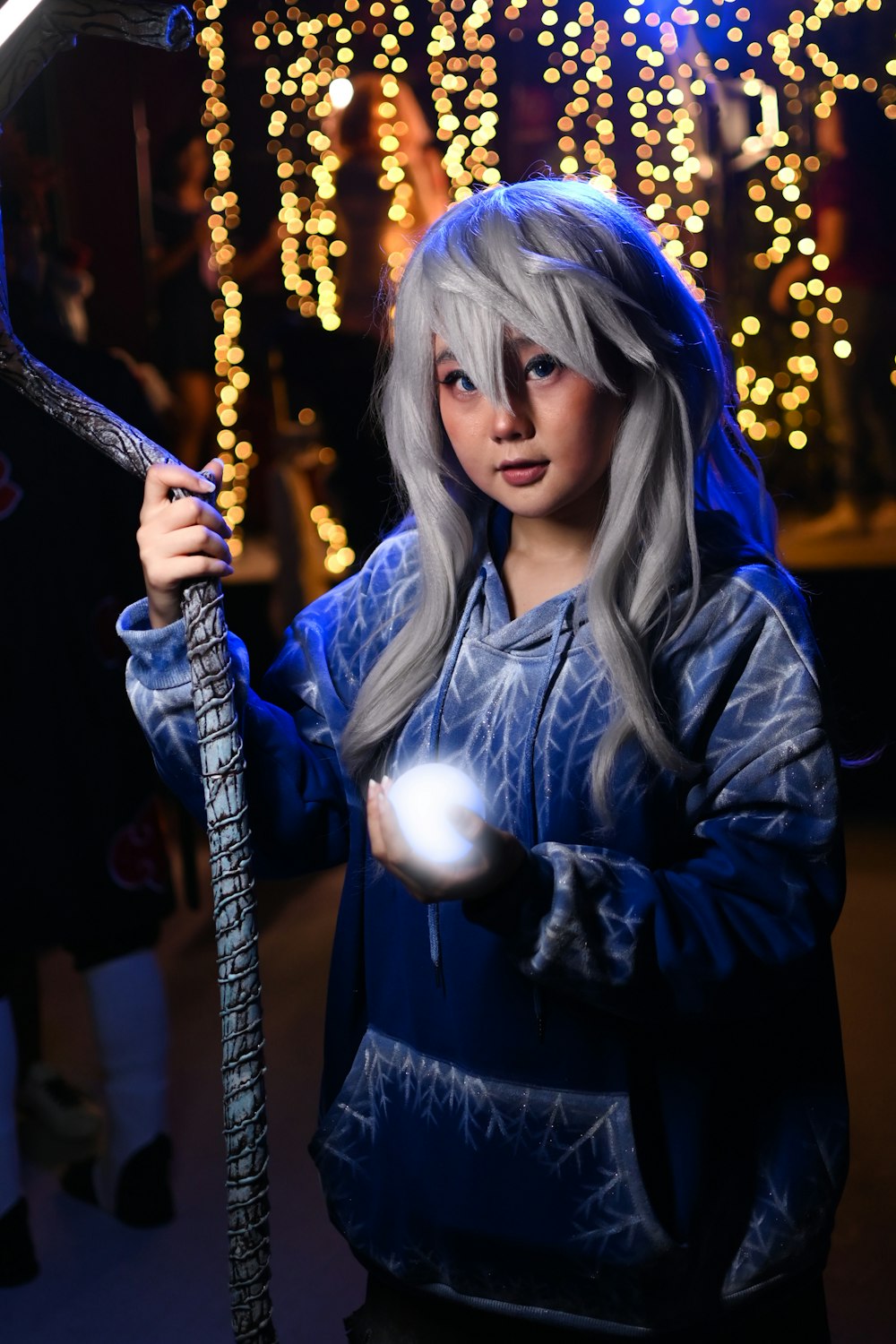 a young girl holding a baseball bat and a ball