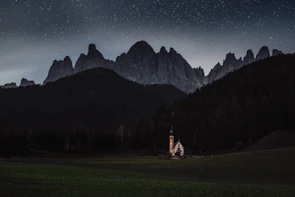 A small group gathered outdoors in Montana-style scenery, engaged in heartfelt worship.