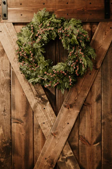 a christmas wreath on a wooden door
