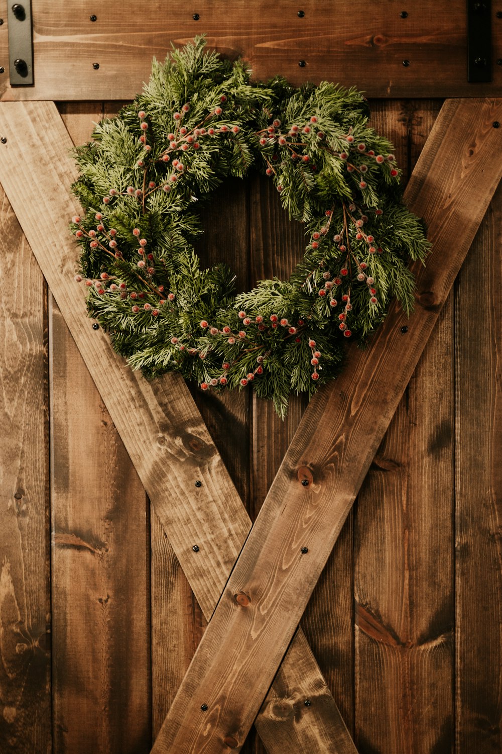a christmas wreath on a wooden door