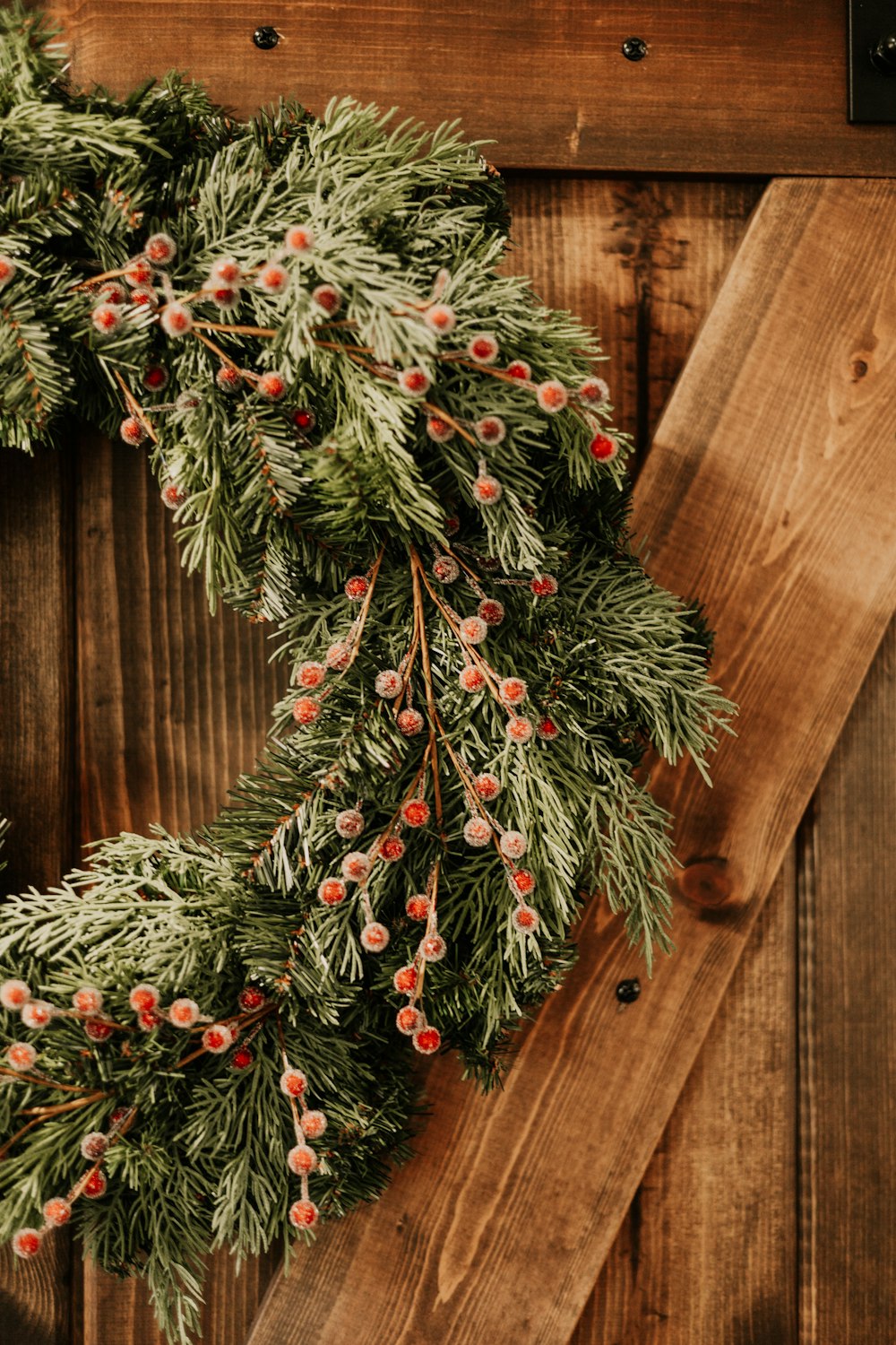 a close up of a wreath on a wooden door
