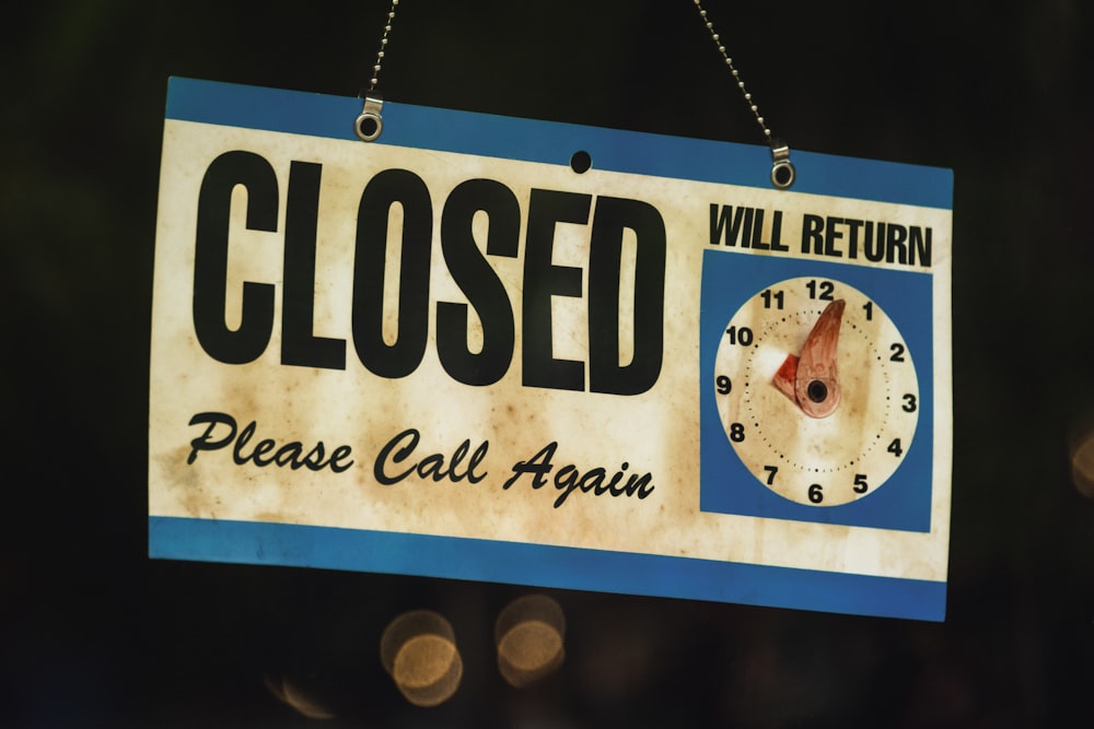 a close up of a sign with a clock on it