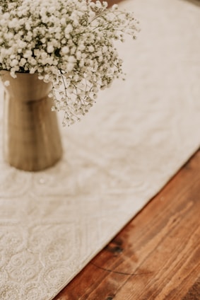 Elegant floral arrangement with neutral tones displayed on a wooden table