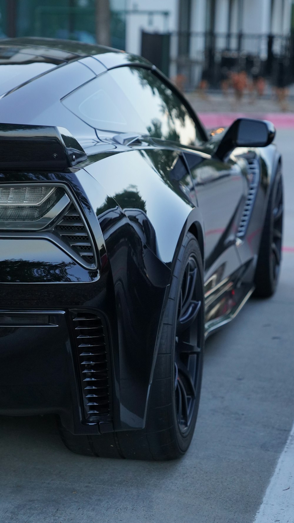 a black sports car parked on the side of the road