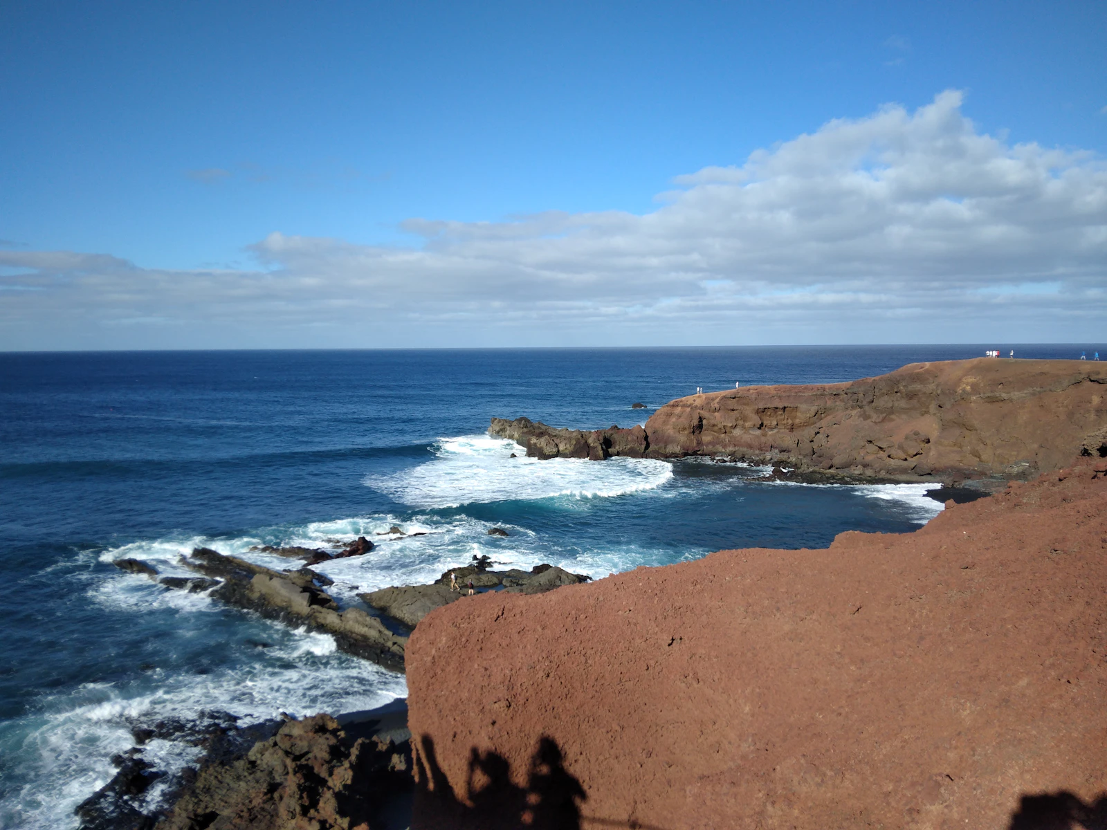 Dark lava rock and surf along the coast — Lanzarote, Spain